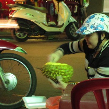 serving a durian at a vietnamese market